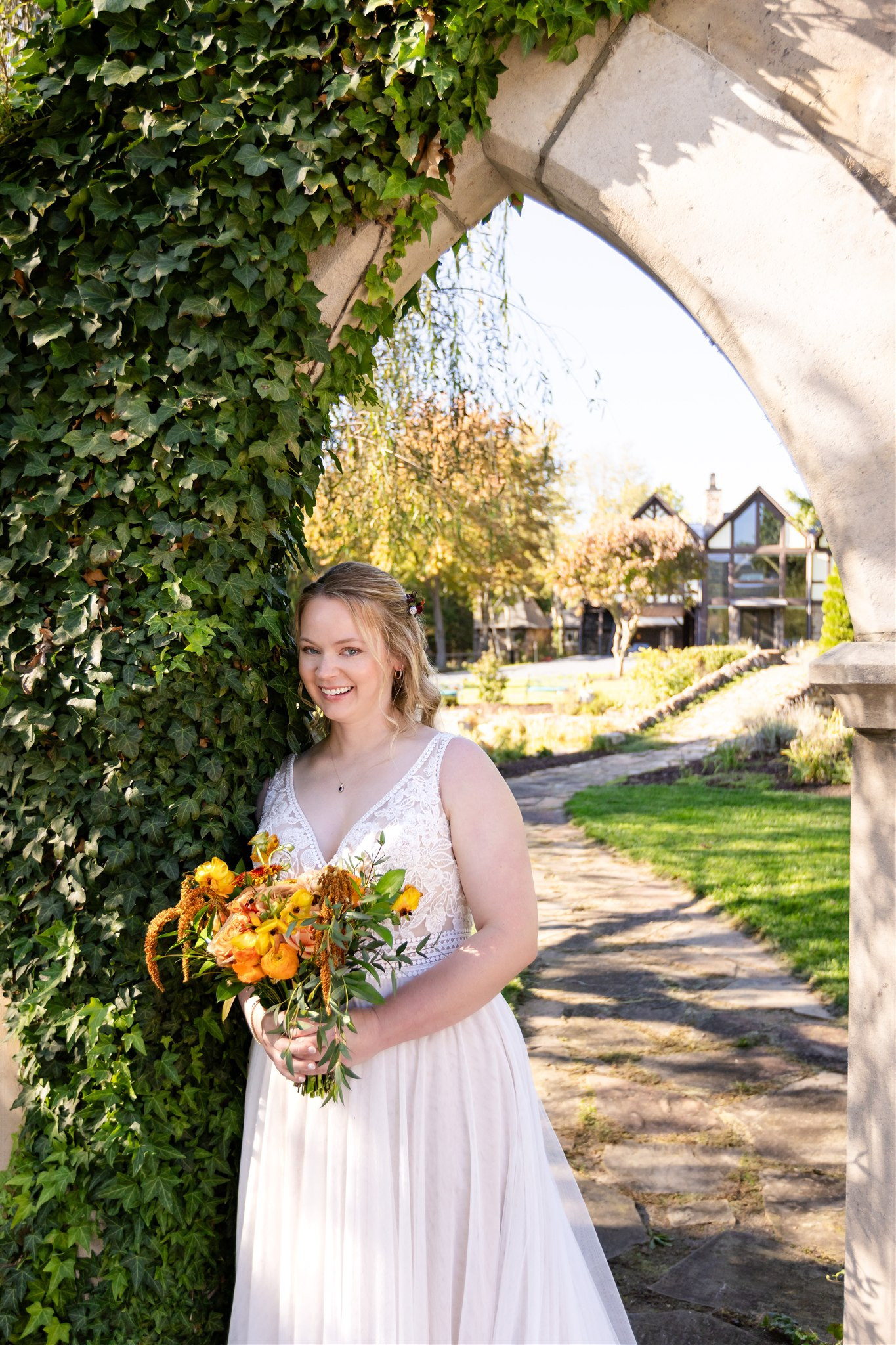 Bride with bouquet at Brenden and Selena's Grottoes, VA wedding estate.