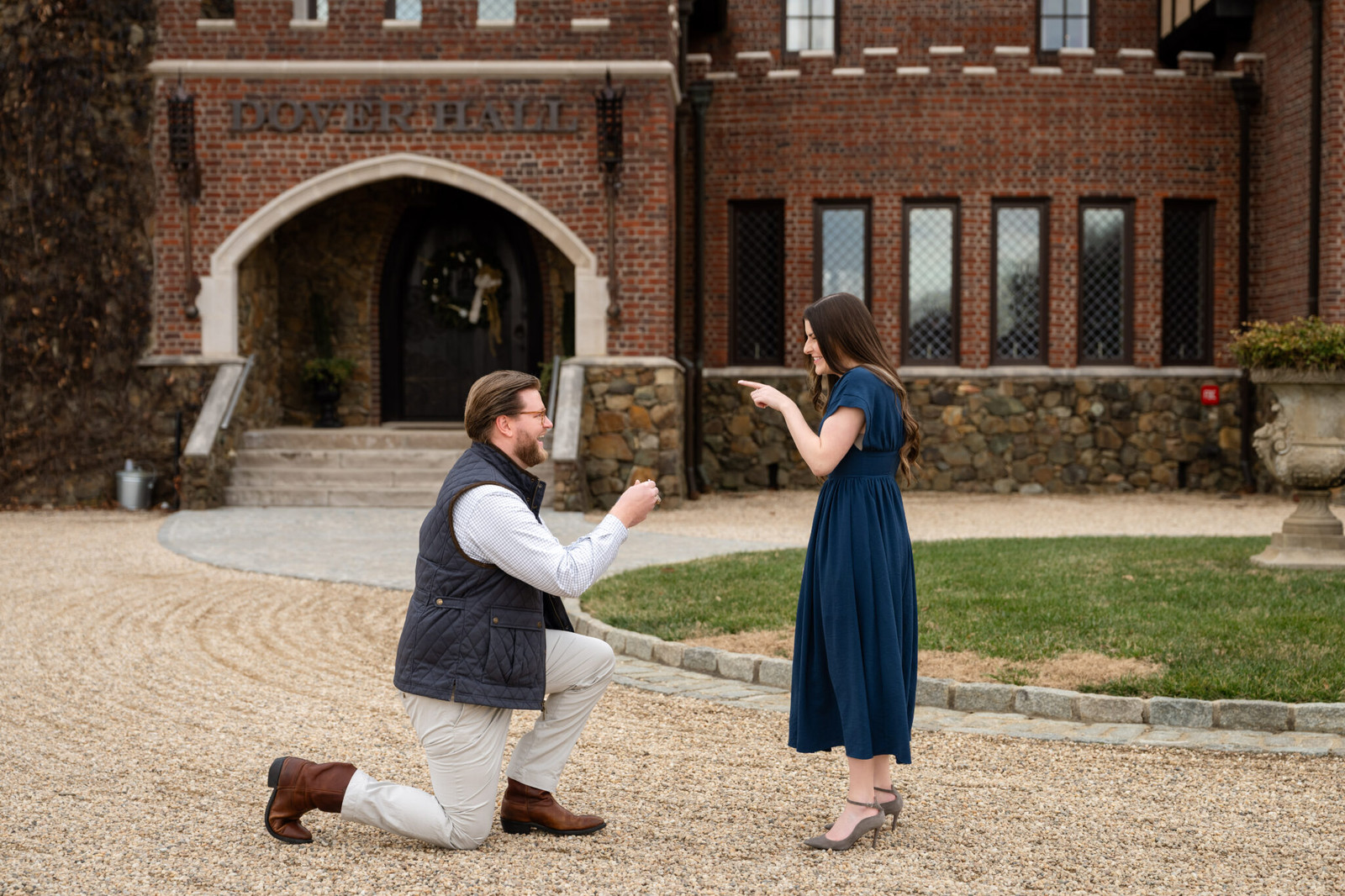Man proposes to woman in front of Dover Hall