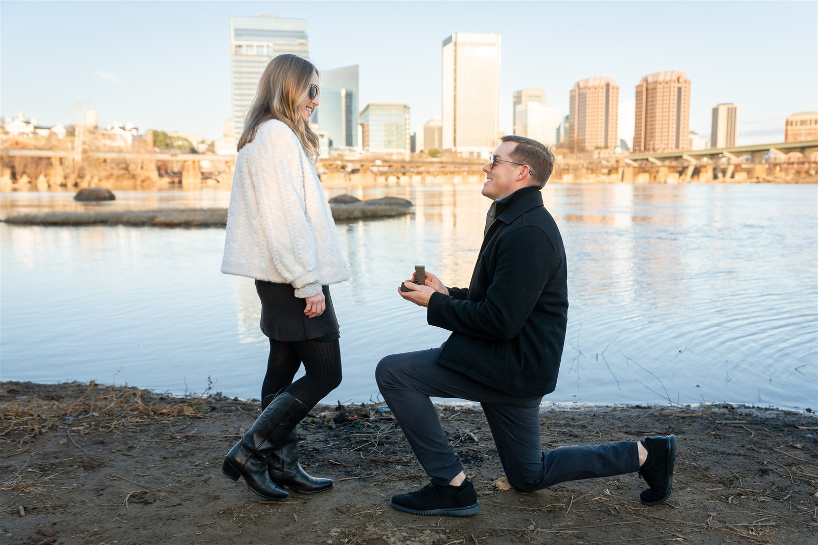 Richmond proposal: Man kneeling with ring, city skyline backdrop.
