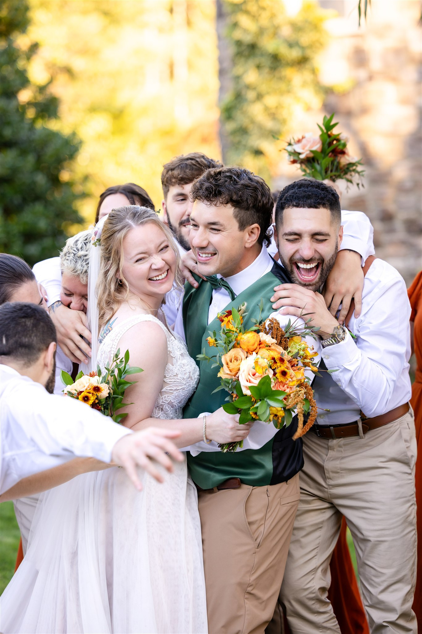 Bride and groom embraced by wedding party at Grottoes, VA estate.